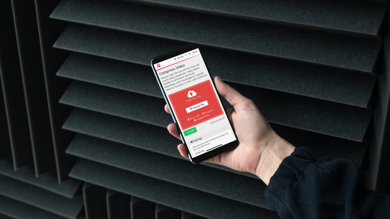 A person holding a smartphone and using Compress2Go to compress video on an Android phone