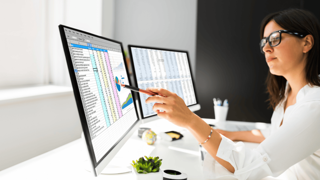 A woman working in Excel, using top Excel features.