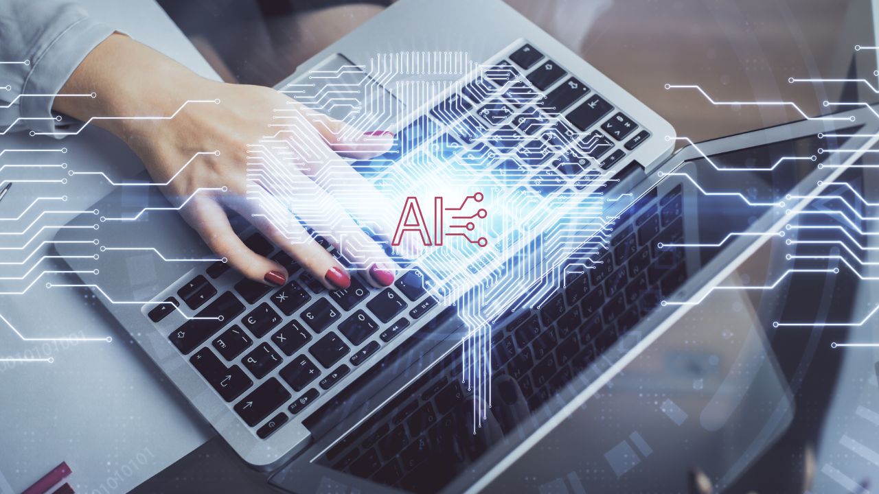 6 AI tools you need to know about - a woman's hand on a laptop